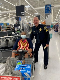 image of a cop posing with an elderly woman