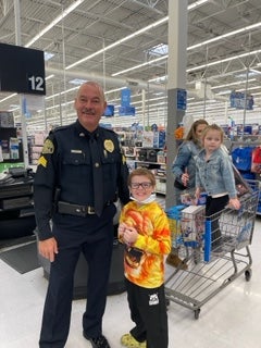 image of a cop posing with kids